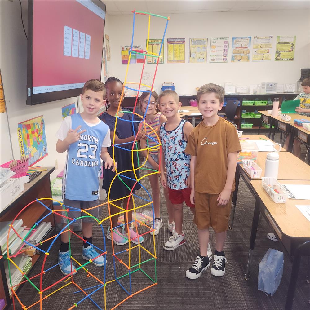 Students stand next to an activity at Rice Elementary School